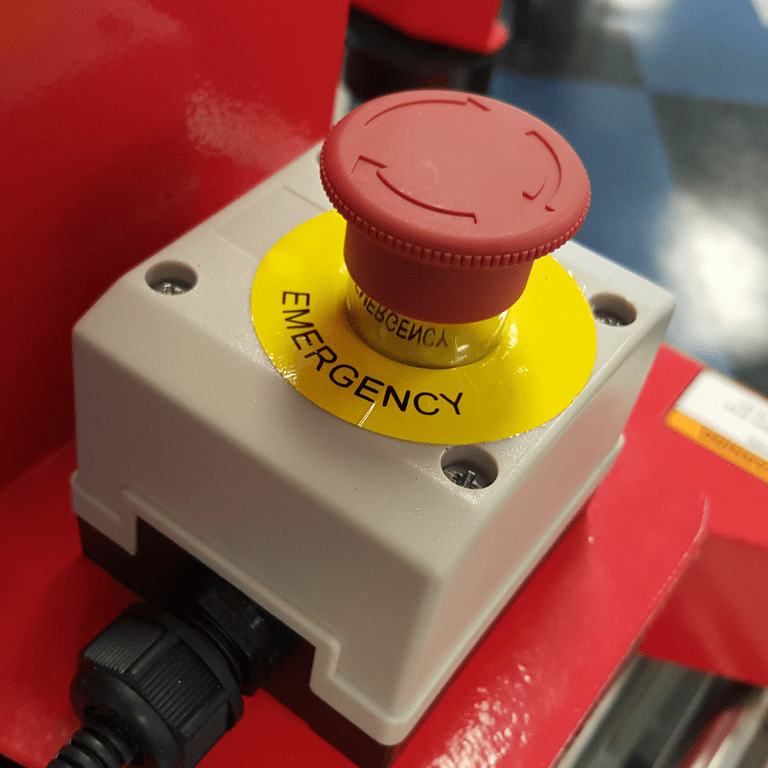 Red mushroom emergency stop button on yellow collar