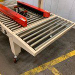 Industrial conveyor belt with red components