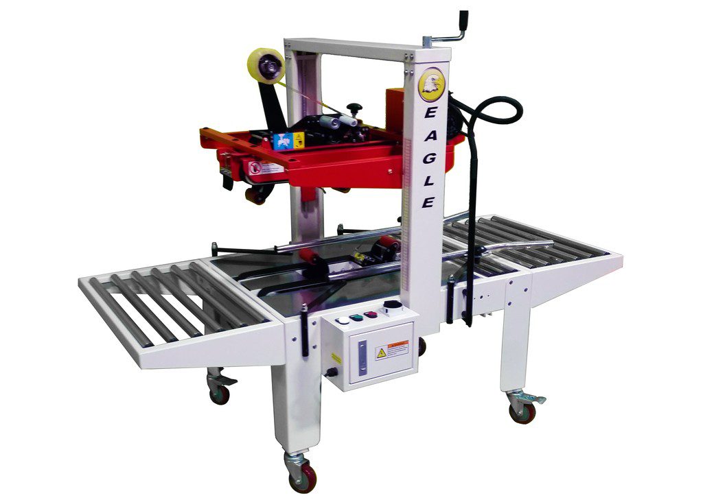 Packaging machine with rollers and tape dispenser.