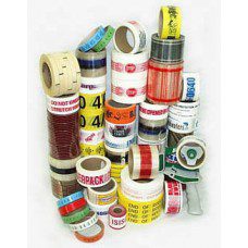 Assorted rolls of colorful adhesive and packaging tapes stacked together.