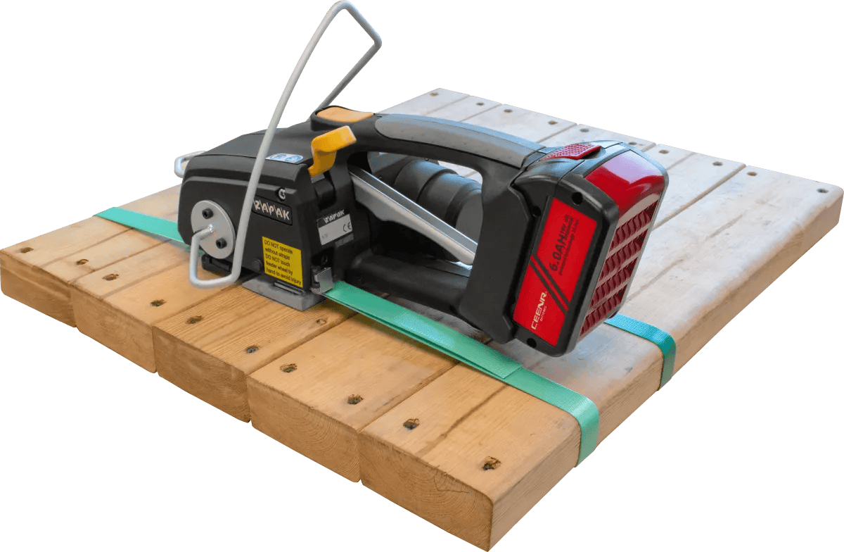 Battery-powered strapping tool on wooden pallet