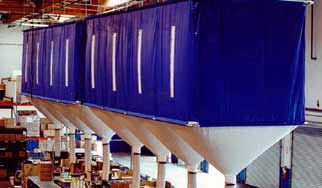 Suspended blue fabric enclosures over white hoppers